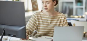 Young woman works on documents on a PC